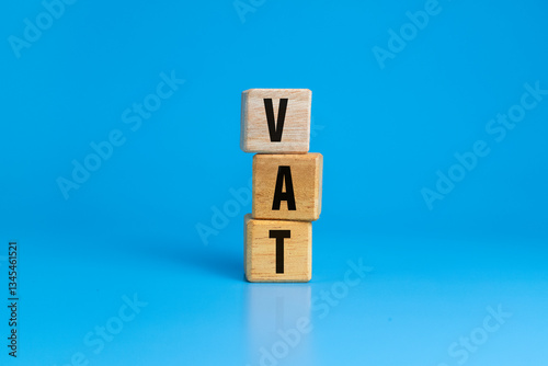 vat letter symbol or value added tax on wooden blocks isolated on blue background