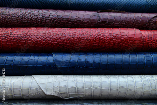 stack of Rolled leather sheets in various colors and textures.
