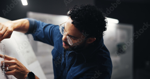 Architect, man and paper on drawing board for floor plan, urban development project or building design blueprint. Night, deadline or person with sketching for property renovation and expansion layout