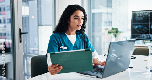 Woman, nurse or reading with laptop or tablet for medical research, discovery or study at hospital. Female person, healthcare worker or employee with technology for telehealth or health app at clinic