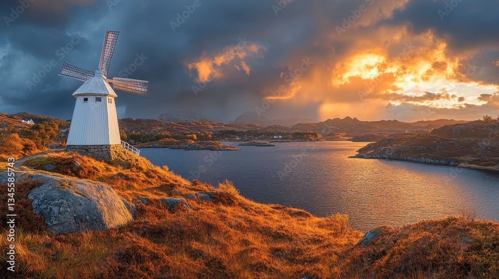 Fototapeta premium Dramatic sunset over a windmill by the water coastal landscape nature photography scenic view