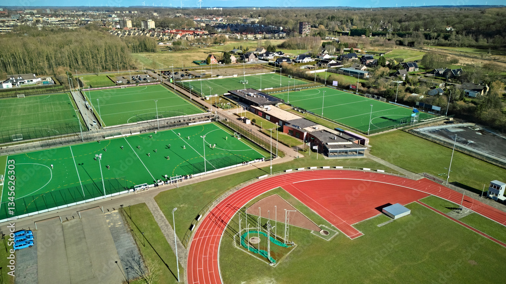 Obraz premium Sportpark with soccer fields and running track aerial drone view from above, football and athletic stadium bird’s view, sport and fitness infrastructure facilities in the Netherlands