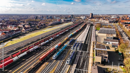 Railroad, train tracks and trains aerial drone view from above, railway station in the Netherlands, transportation, logistics and public transport infrastructure concept