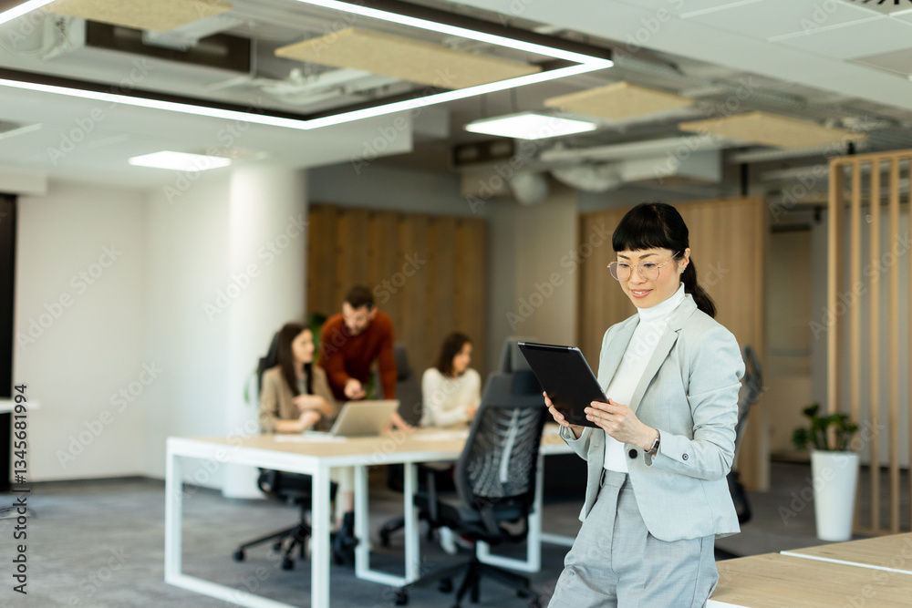 Business professionals collaborate in a modern office setting with technology at their fingertips Business professionals collaborate in a modern office setting with technology at their fingertips