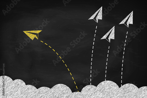 Individual and yellow paper plane changing direction around the clouds on black chalkboard
