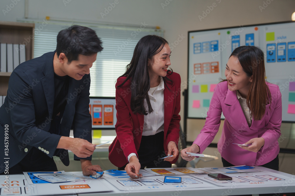 Fototapeta premium Asian web designers working on user interface and user experience of mobile application