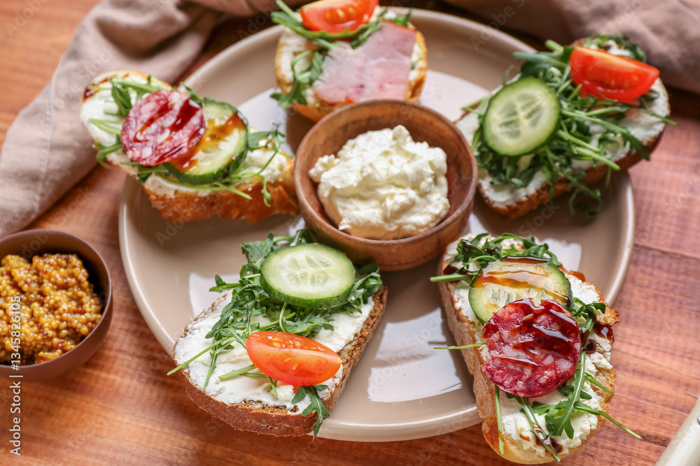 Plate with delicious sandwiches, cream cheese and mustard on wooden table, closeup Plate with delicious sandwiches, cream cheese and mustard on wooden table, closeup