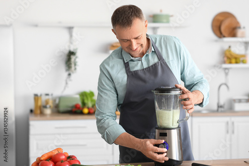 Mature man making smoothie ...