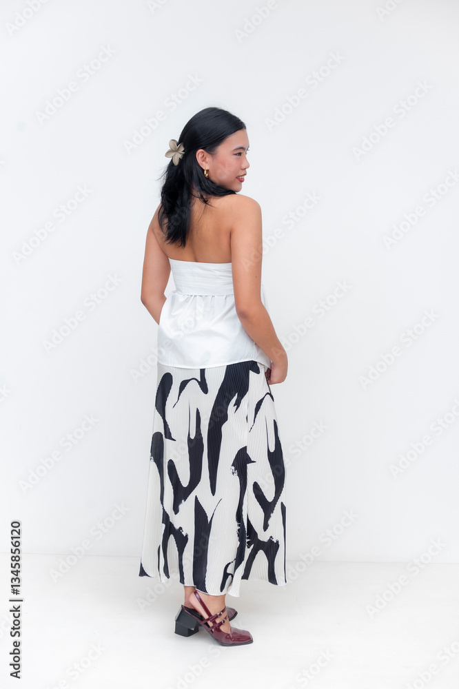 Fashionable Asian woman modeling stylish outfit on white background Fashionable Asian woman modeling stylish outfit on white background