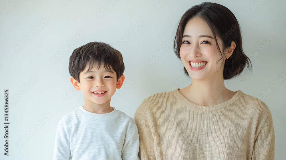 Studio Portrait of a Happy Asian Mother and Daughter: A Family Concept Featuring a Japanese Young Mother and Her Cute Son Interacting and Smiling in Front of a Plain White Background Studio Portrait of a Happy Asian Mother and Daughter: A Family Concept Featuring a Japanese Young Mother and Her Cute Son Interacting and Smiling in Front of a Plain White Background