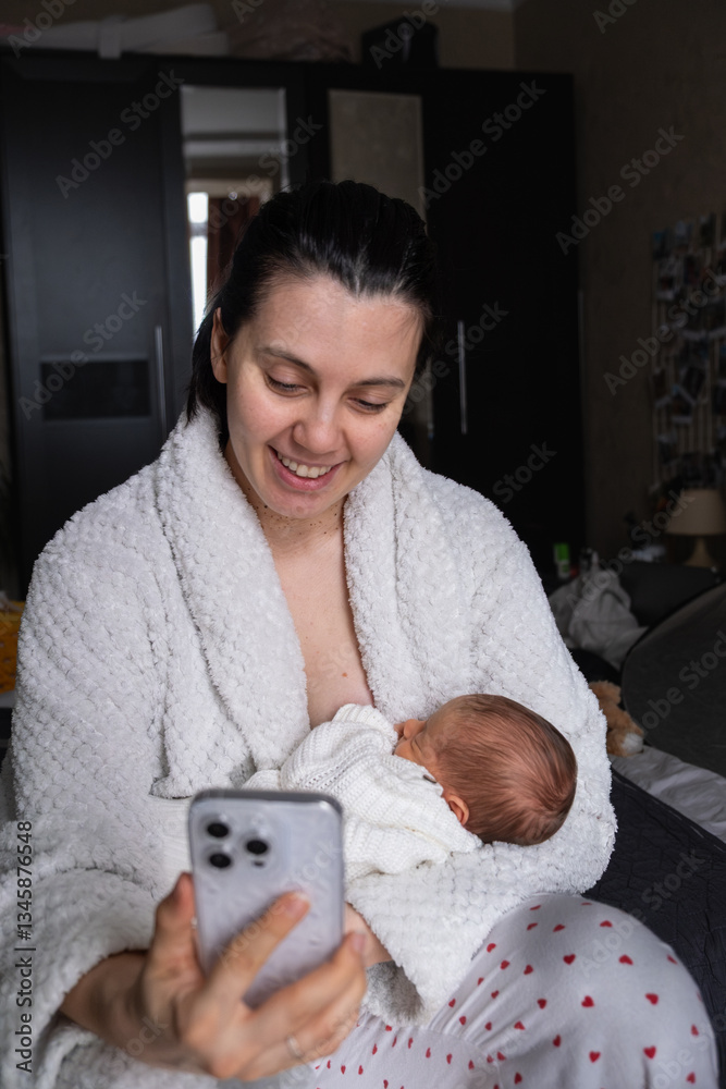 Mother Smiling at Smartphone with Newborn Baby
