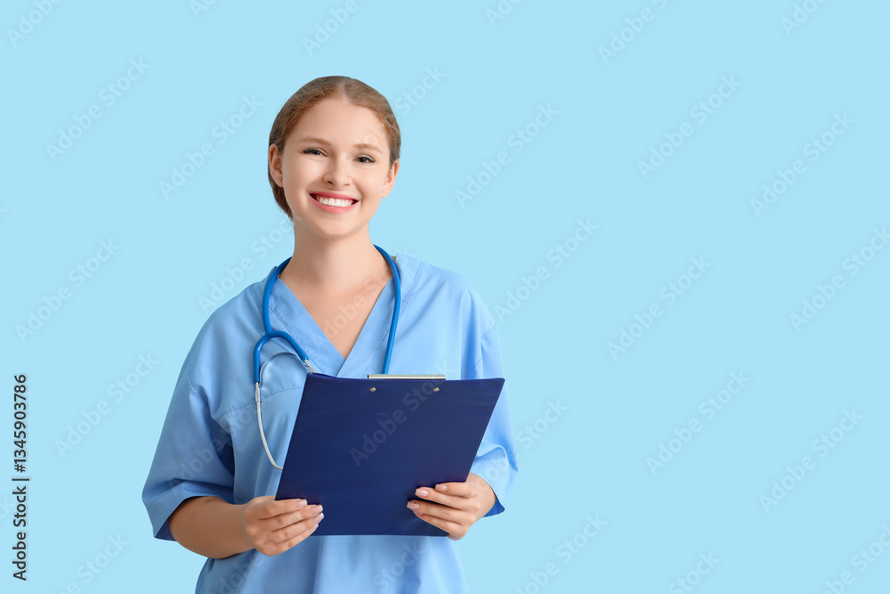 Female medical student with clipboard on blue background Female medical student with clipboard on blue background