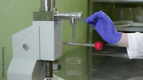 The process of filling red liquid collagen into containers for further sale.