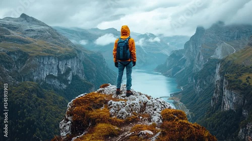 hiker on top of mountain, showing success while clmbing a mountain 