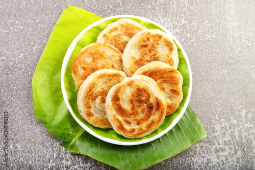 Bun porotta - a traditional street food or snack served with spicy curry.