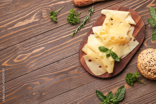 Photos Board with tasty cheese slices and bread on wooden background