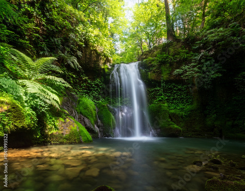 A cascading waterfall surrounded by lush greenery captured with soft lighting to represent freshness and purity