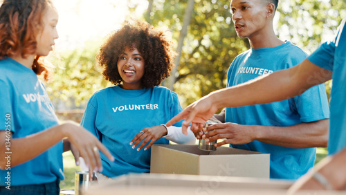 People, volunteer and boxes of donation at park for giving food, packing supplies and community aid. Staff, helping and sorting products for charity outreach, teamwork and distribution of NGO welfare photo