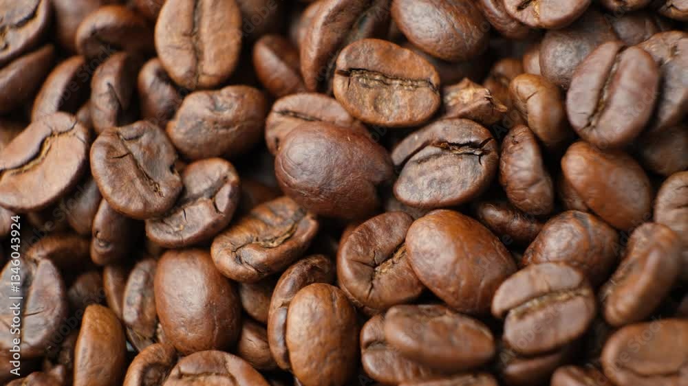 Rotating a pile of caffeine-free decaf coffee beans close-up Rotating a pile of caffeine-free decaf coffee beans close-up