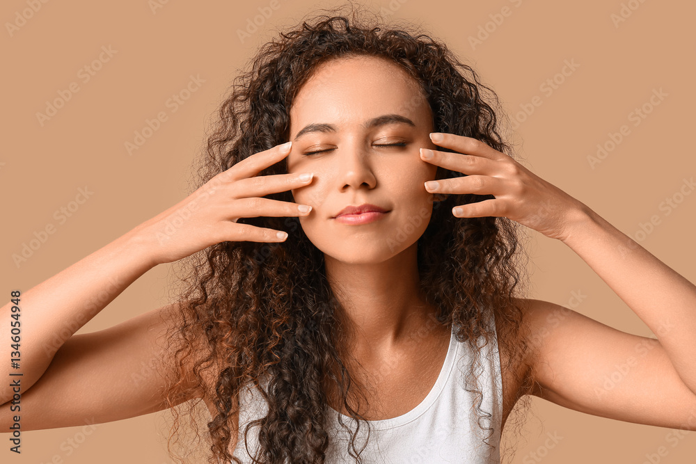 Fototapeta premium Beautiful young African-American woman with healthy moisturized skin on beige background