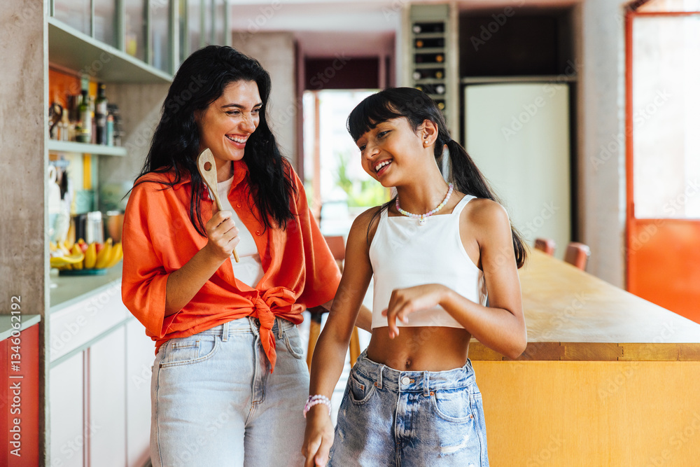 Happy mother and daughter spending quality time together in a bright kitchen Happy mother and daughter spending quality time together in a bright kitchen