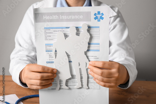 Female doctor holding famil...