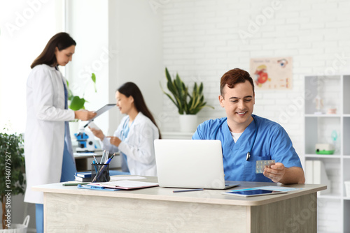 Male doctor with pills at t...