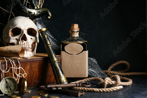 Skull with spyglass, rum and rope on dark background. Pirate concept