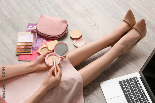 Makeup artist with cosmetic...