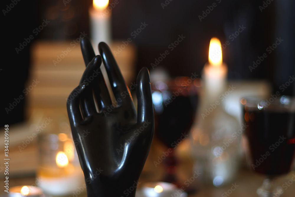 Books, lit candles, red wine, snacks and various deocration on the table. Dark academia or Halloween concept. Selective focus.