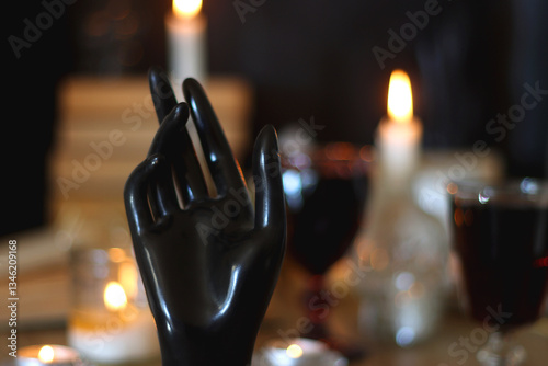 Obraz na płótnie Books, lit candles, red wine, snacks and various deocration on the table. Dark academia or Halloween concept. Selective focus. w salonie