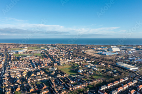 Obraz na płótnie Aerial drone photo of the town of Hartlepool in the UK showing rows of terrace houses and homes and typical British suburban housing estates with the ocean in the background in the winter time w salonie