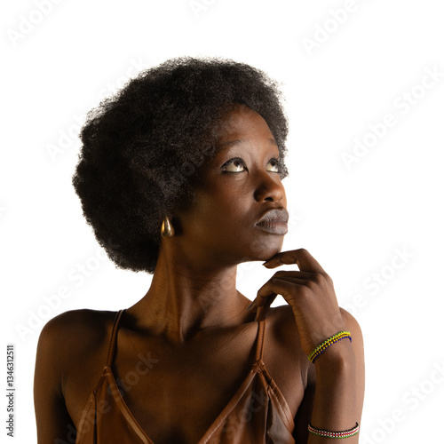 A thoughtful young woman with curly hair gazes upward..