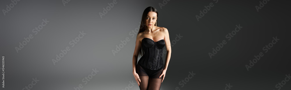 Naklejka premium Stylish young woman showcasing modern fashion trends in a chic studio environment