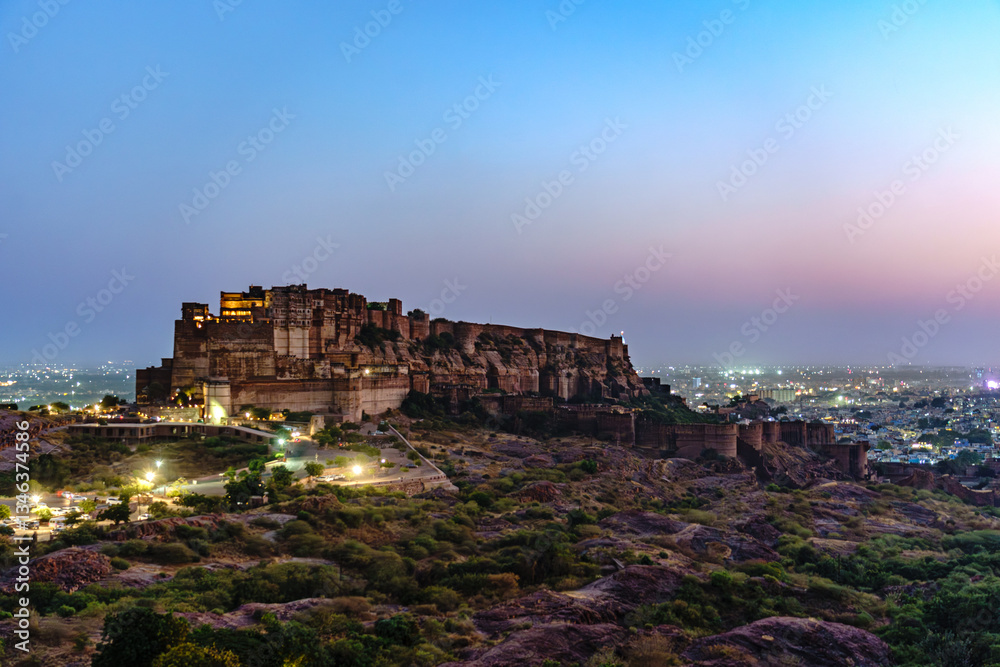 Fototapeta premium India. State of Rajasthan. Jodhpur. General view of Mehrangarh Fort (historic stronghold of the Rathore Rajput royal rulers). Outer walls and ramparts at nightfall
