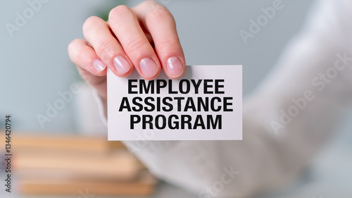 A person is holding a white card that says Employee Assistance Program photo