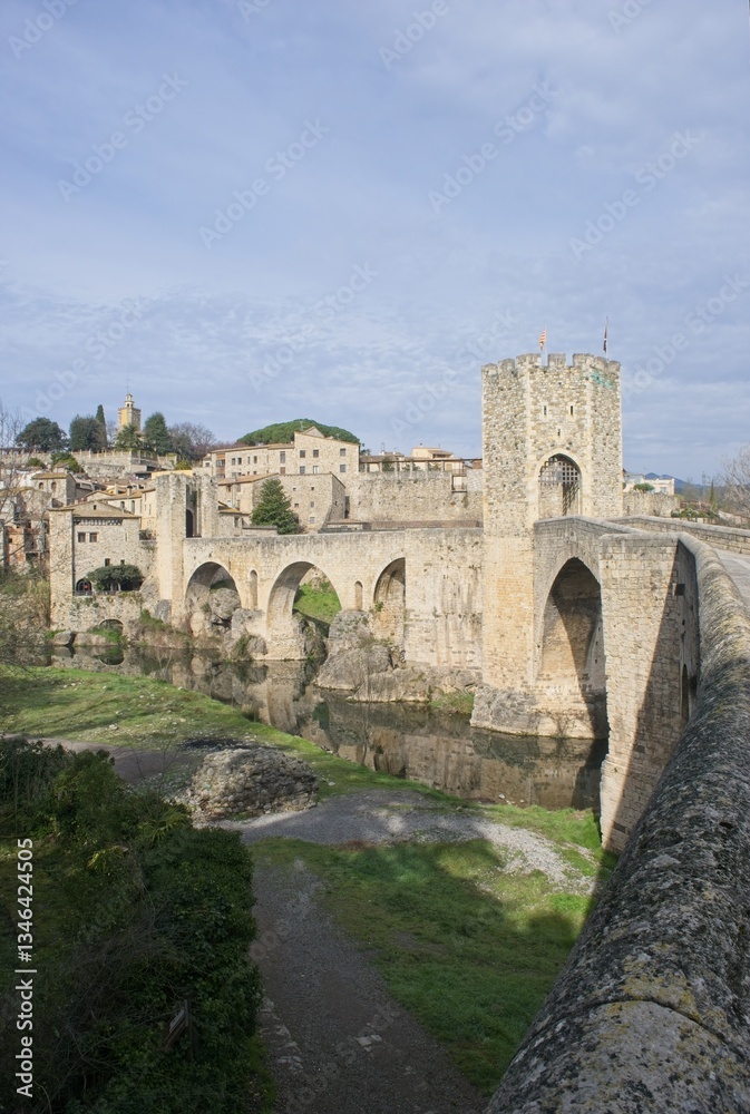 Besalu, Spain - Feb 24, 2025: People walking on Besalu bridge. Streets, buildings. Lifestyle in the urban area. Sunny winter day. Selective focus Besalu, Spain - Feb 24, 2025: People walking on Besalu bridge. Streets, buildings. Lifestyle in the urban area. Sunny winter day. Selective focus