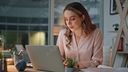 Late businesswoman using laptop in cozy office closeup. IT employee taking notes