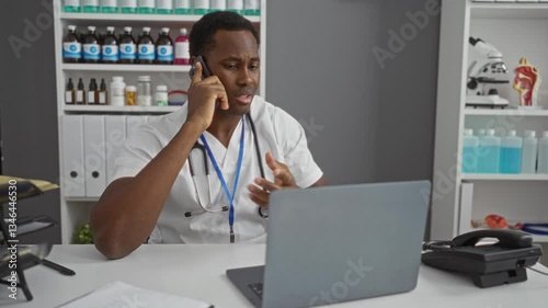 Wallpaper Mural Doctor communicating on phone in hospital office with laptop stethoscope shelves files Torontodigital.ca