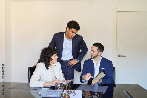 Lawyers working together on a case using digital tablet in office