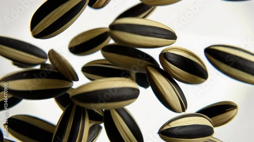 Floating black seeds with gold design create stunning pattern of unique textures and colors.