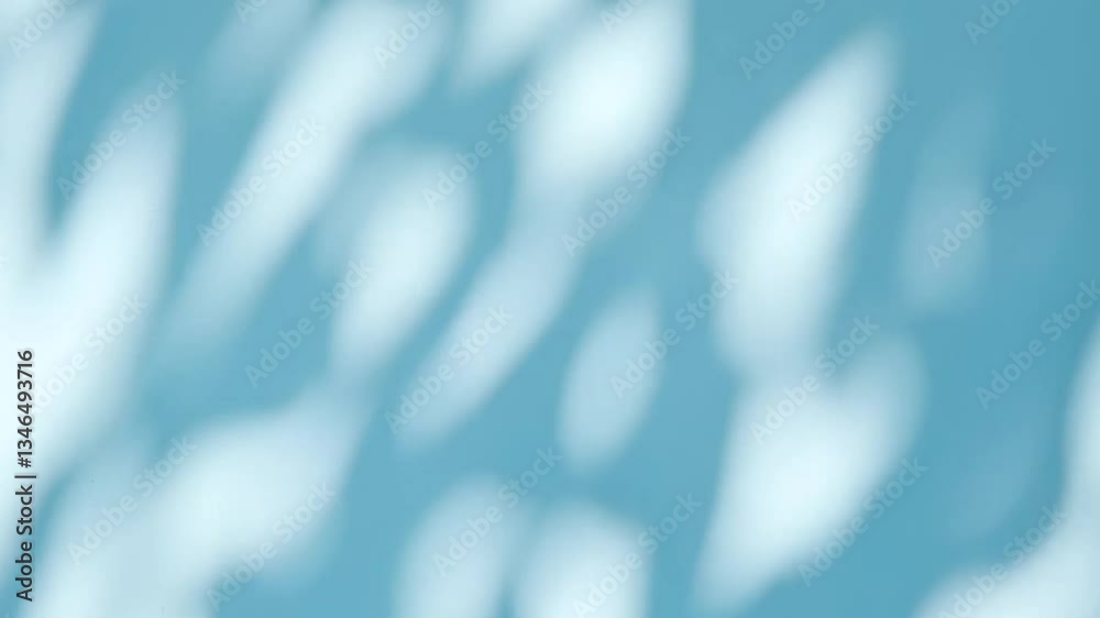 Abstract silhouette shadows of natural leaves tree branch falling on a light blue wall background. Transparent blurry shadow in morning sunlight with copy space for text,4K