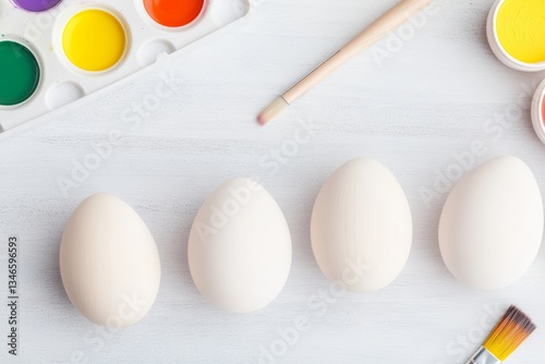 Blank Wooden Easter Eggs with Paints and Brushes on Light Background for DIY Decoration