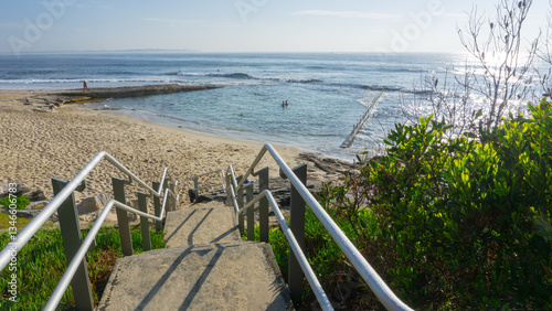 Steps and handrails leading down to beach and Oak Park ocean pool photo