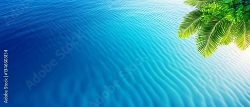 Serene blue water with lush green palm leaves above.