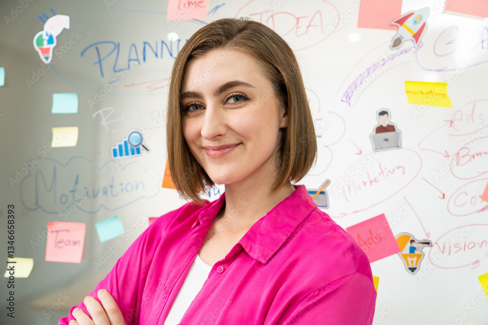 Fototapeta premium Portrait of young beautiful caucasian businesswoman smiling and posing with confident while looking at camera in front of whiteboard with mind map and colorful sticky notes. Closeup. Immaculate.