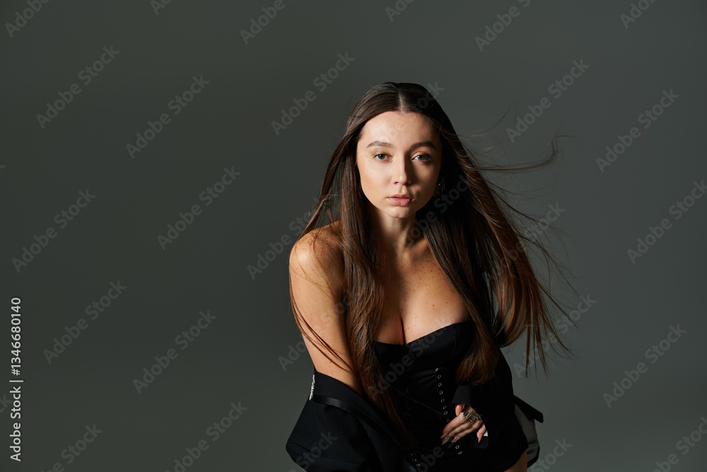 Naklejka premium Beautiful young gymnast demonstrates impressive agility and style in a modern, artistic setup