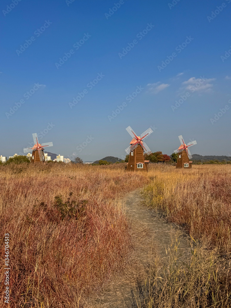 Fototapeta premium Three Windmills in an Autumn Field