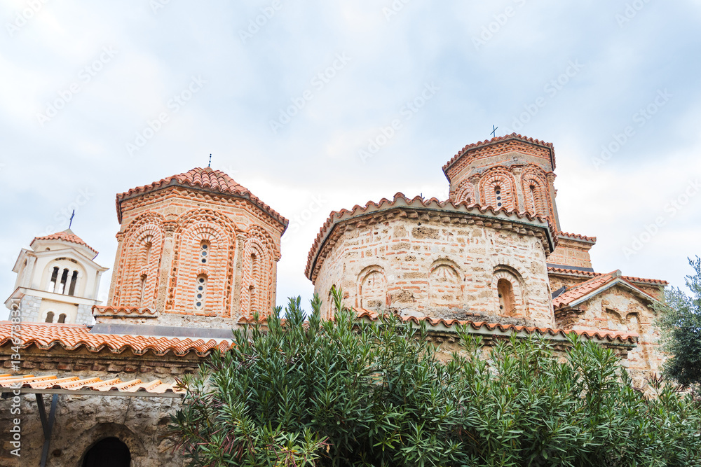 Obraz premium Historic Monastery of Saint Naum with Red-Tiled Roofs and Cylindrical Towers, Ohrid, North Macedonia