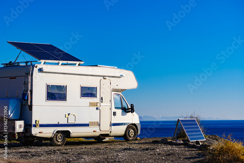 Caravan with tilt solar panels on roof.